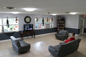 A cozy living room with sofas, a TV, and a bookshelf.