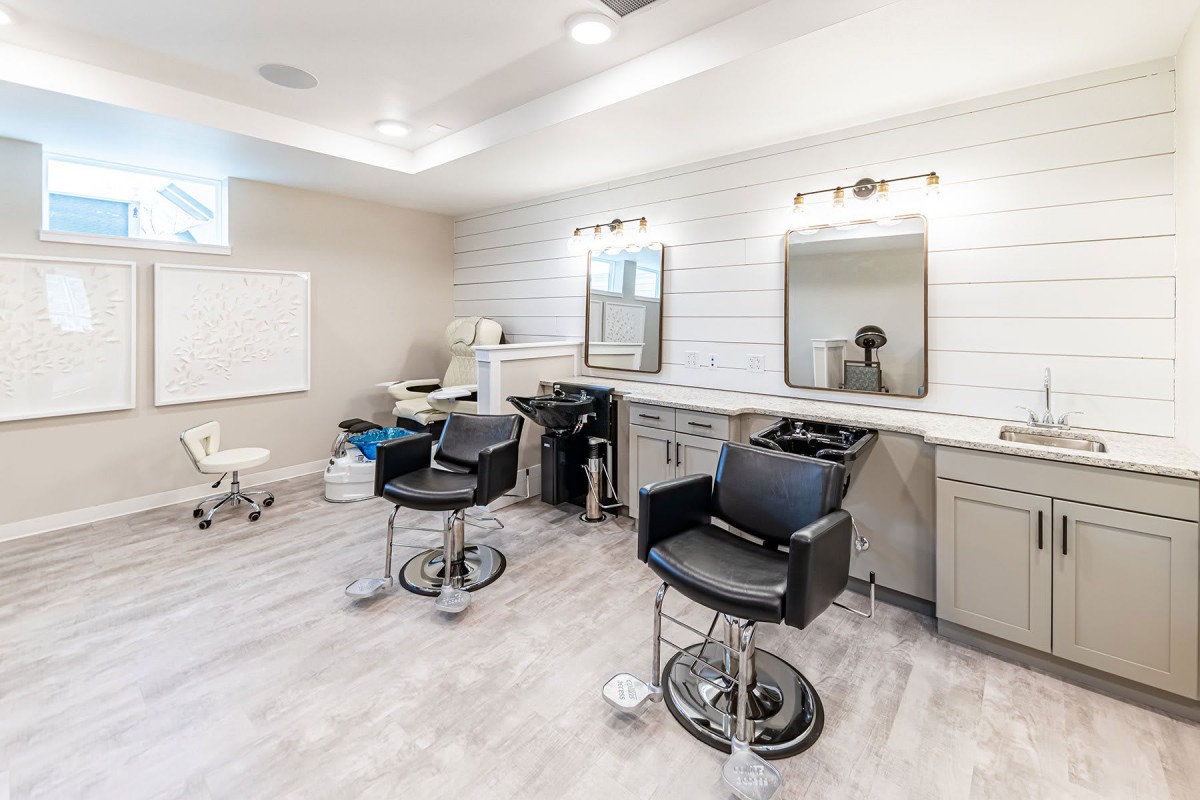 A modern hair salon interior with styling chairs and mirrors.