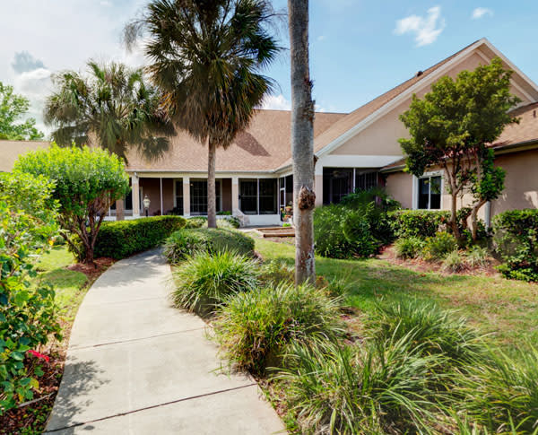 A well-maintained house with a landscaped garden and a pathway leading to the entrance.