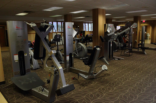 A spacious gym filled with various exercise equipment for fitness enthusiasts.