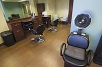 Interior of a hair salon with styling stations and chairs.