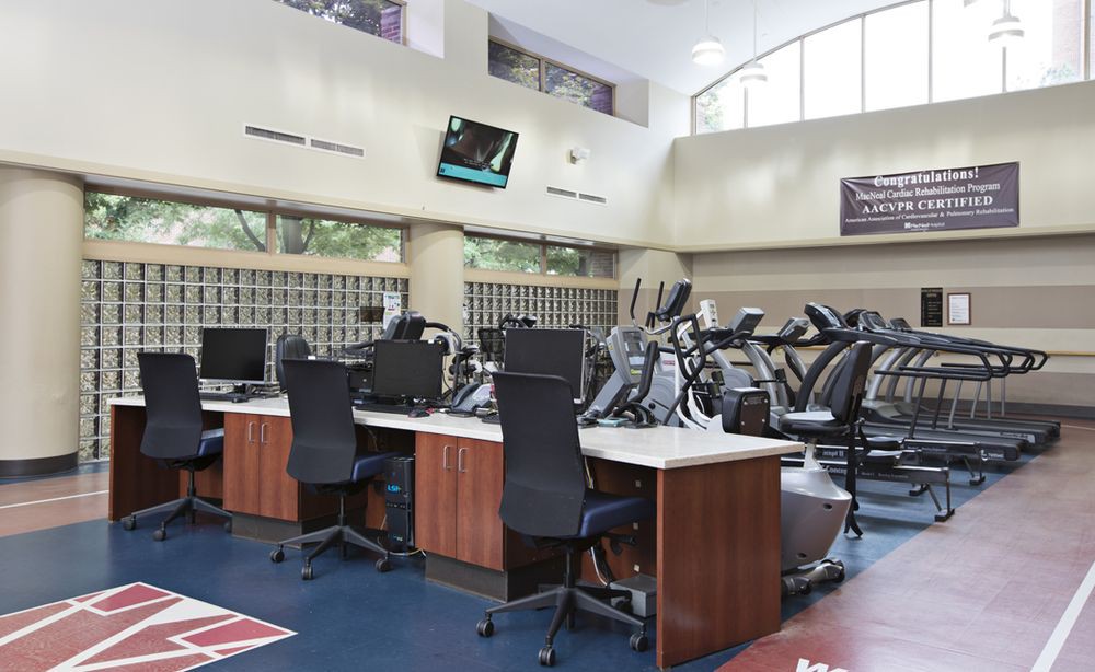 A well-equipped fitness center with cardio machines and exercise equipment.