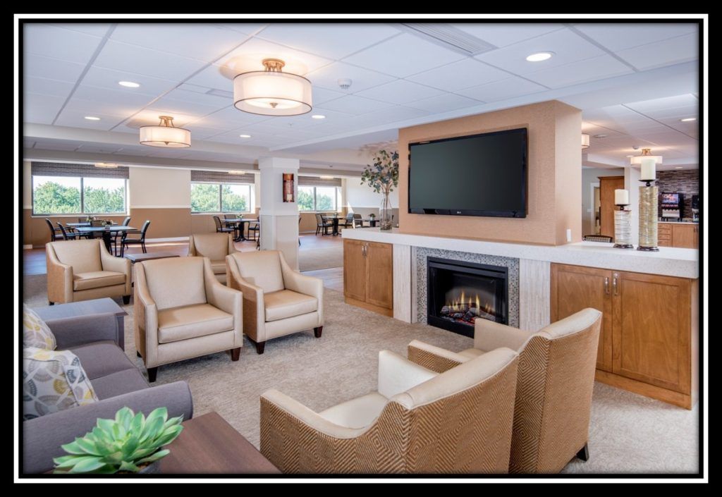 A modern living room with comfortable seating, a fireplace, and a large television.