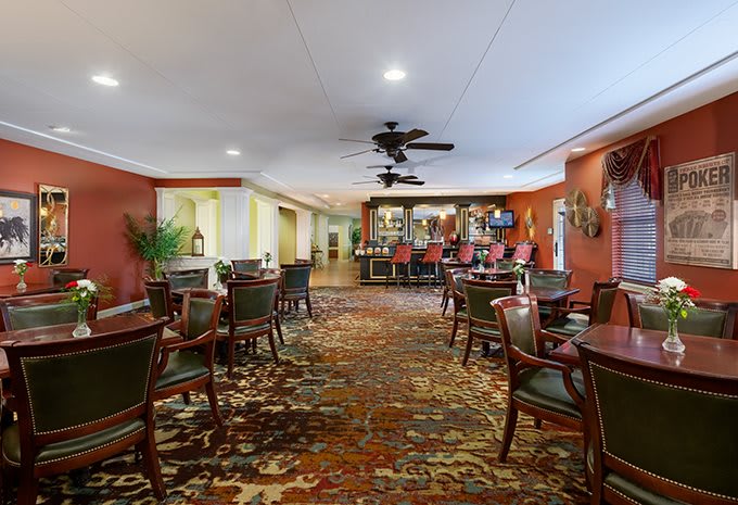 A cozy restaurant bar with elegant seating arrangements and warm lighting.