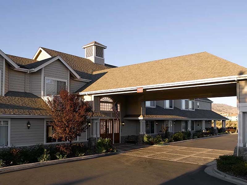 Exterior view of a hotel entrance with overhang.