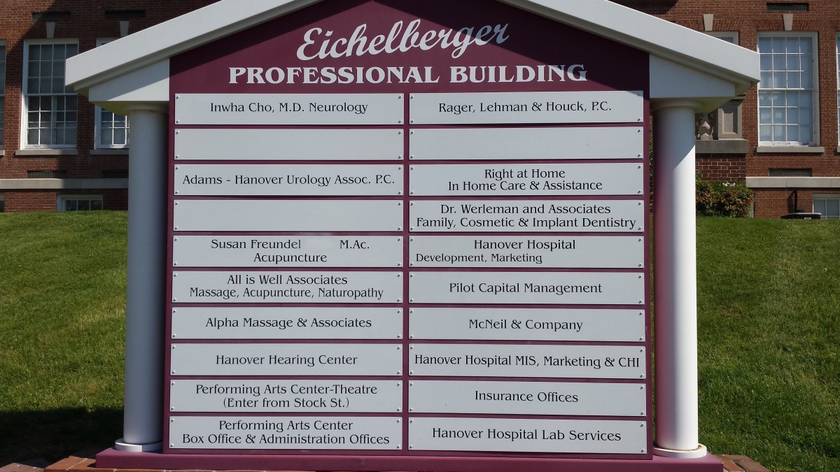 Directory sign for Eichelberger Professional Building listing various offices and businesses.