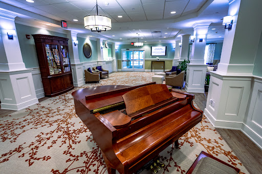 A beautifully designed lobby featuring a polished wooden piano as the centerpiece.