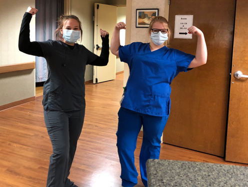 Healthcare workers showing their strength and teamwork while wearing masks.