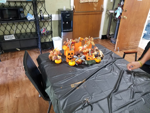 A festive Halloween decoration display featuring pumpkins on a black table.