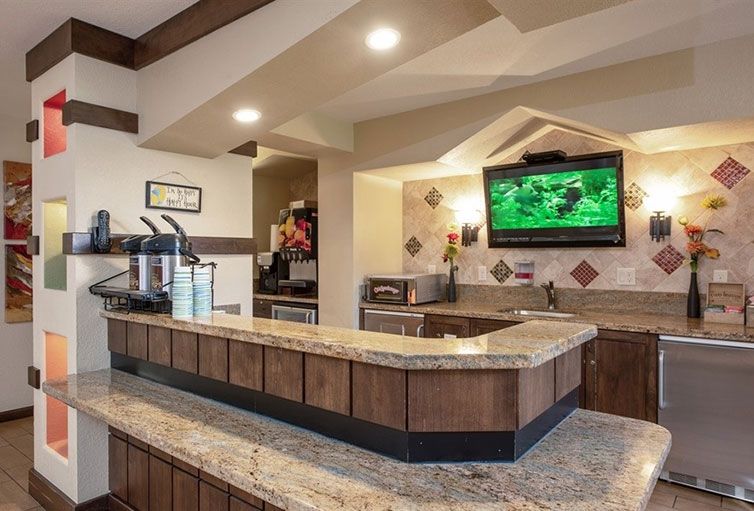 A hotel lobby area featuring a reception counter and a television.