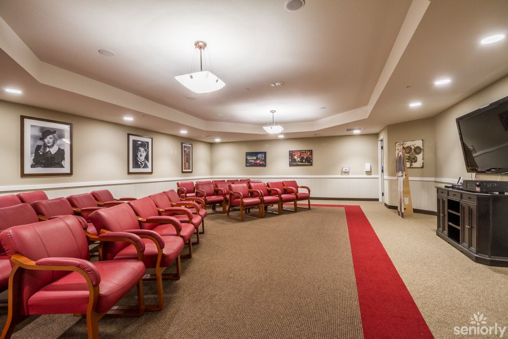 A well-arranged waiting room with red chairs and soft lighting.