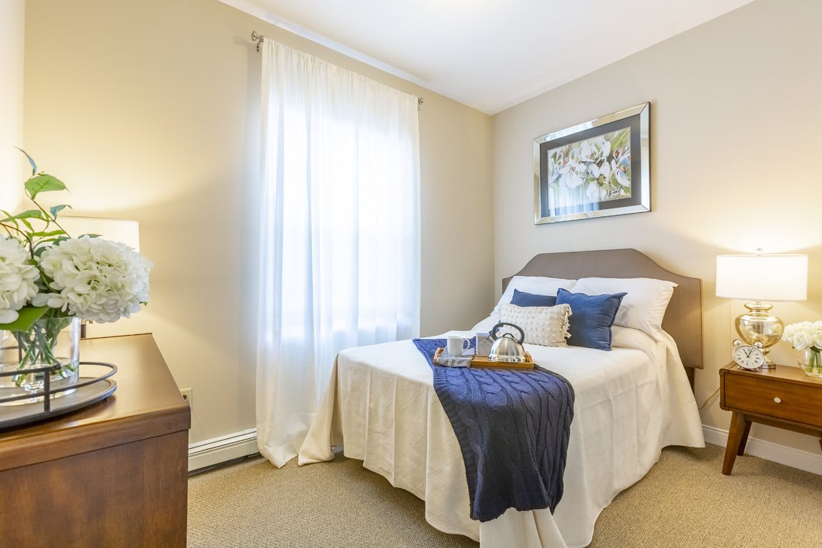 A cozy bedroom with neutral tones and elegant decor.