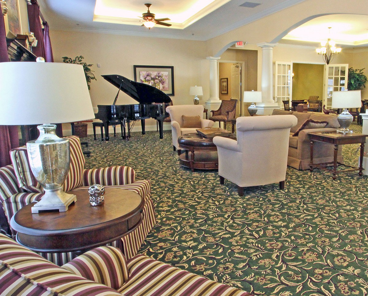 Spacious lobby area with comfortable seating and a grand piano.