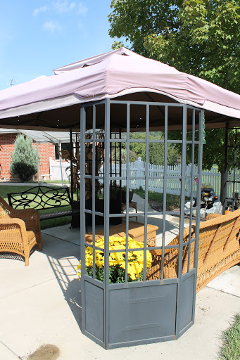 A cozy gazebo in a garden setting, perfect for relaxing and enjoying the outdoors.