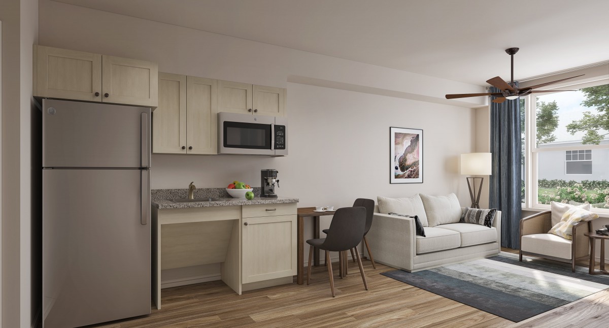 A modern studio apartment with a compact kitchen and cozy living area.