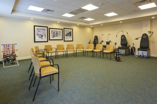 A neatly arranged waiting room with chairs set in a circle.