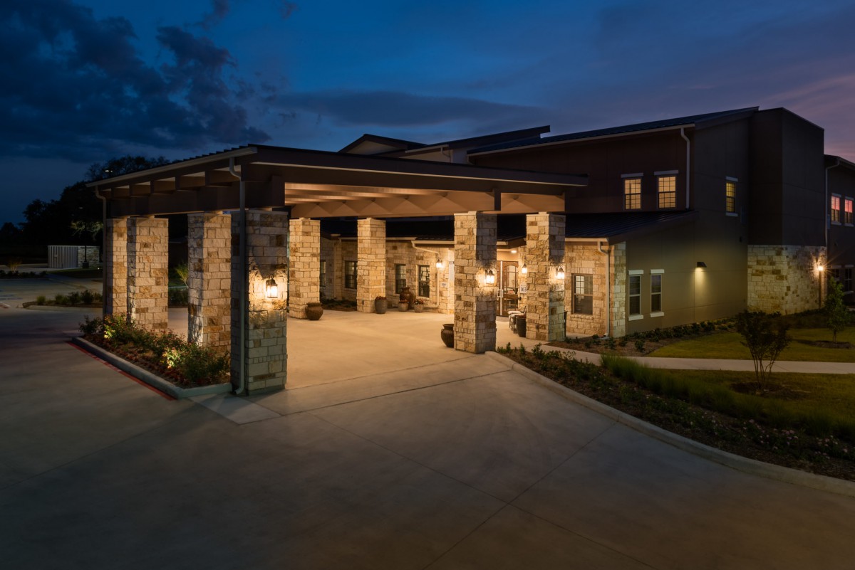 A modern building entrance illuminated at night.