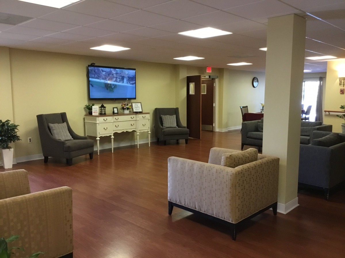 A comfortable lobby area with modern seating and a television.