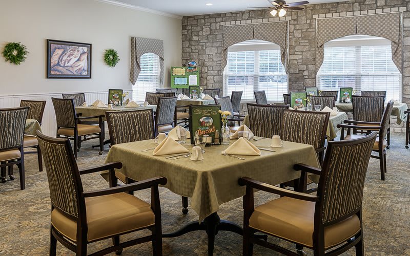 An elegant dining room with neatly arranged tables and chairs.