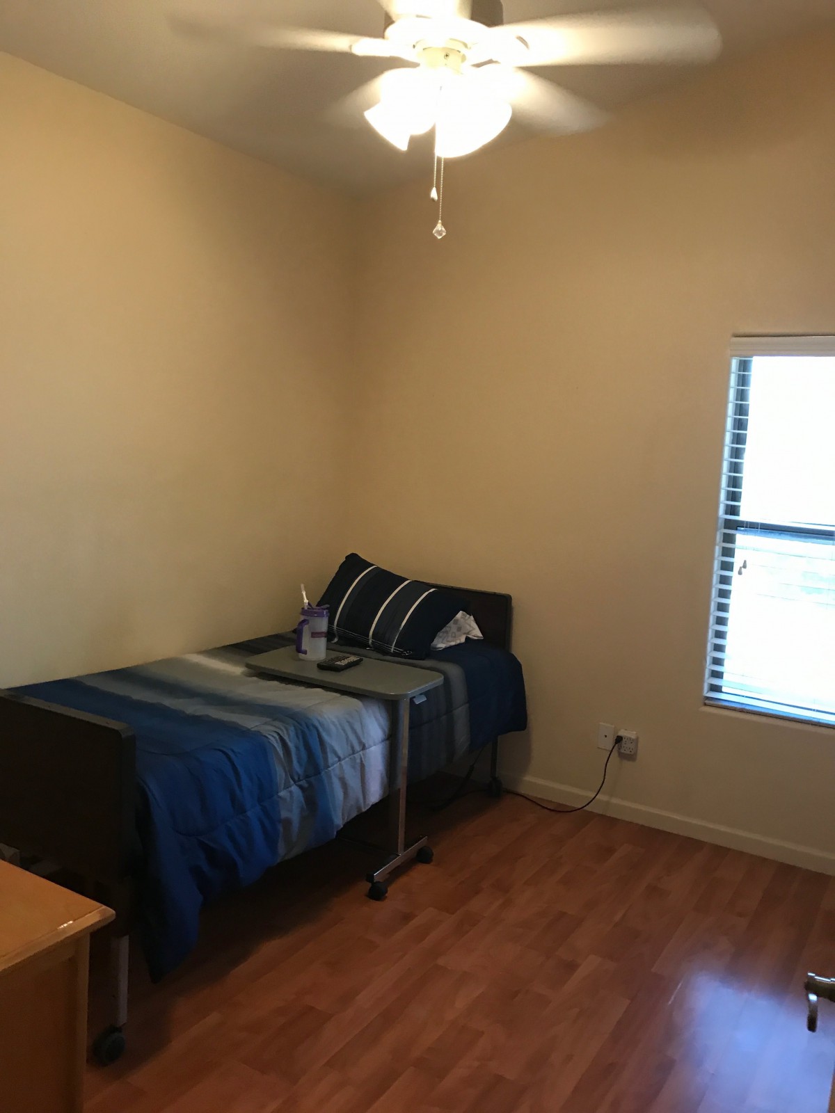 A small bedroom with a single bed and a window providing natural light.