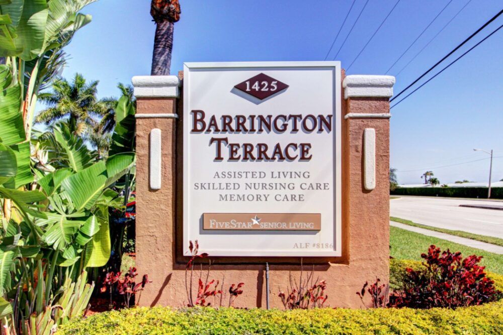 A sign for Barrington Terrace offering assisted living, skilled nursing care, and memory care services.