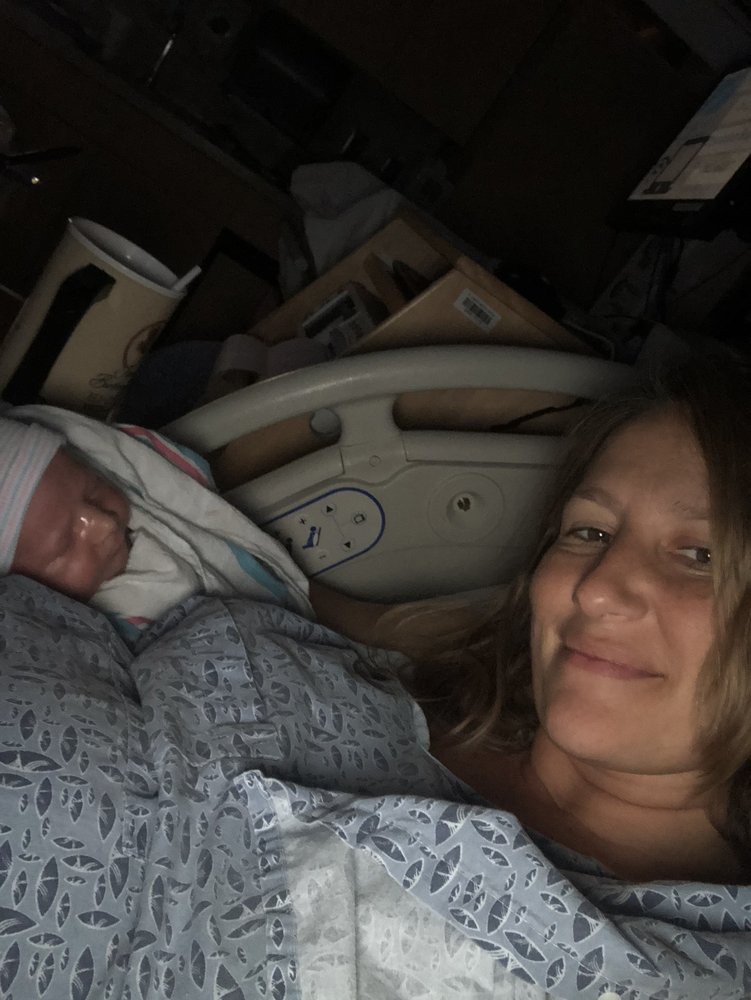 A mother with her newborn in a hospital setting.