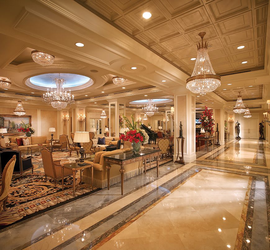 A luxurious hotel lobby with elegant chandeliers and sophisticated interior design.