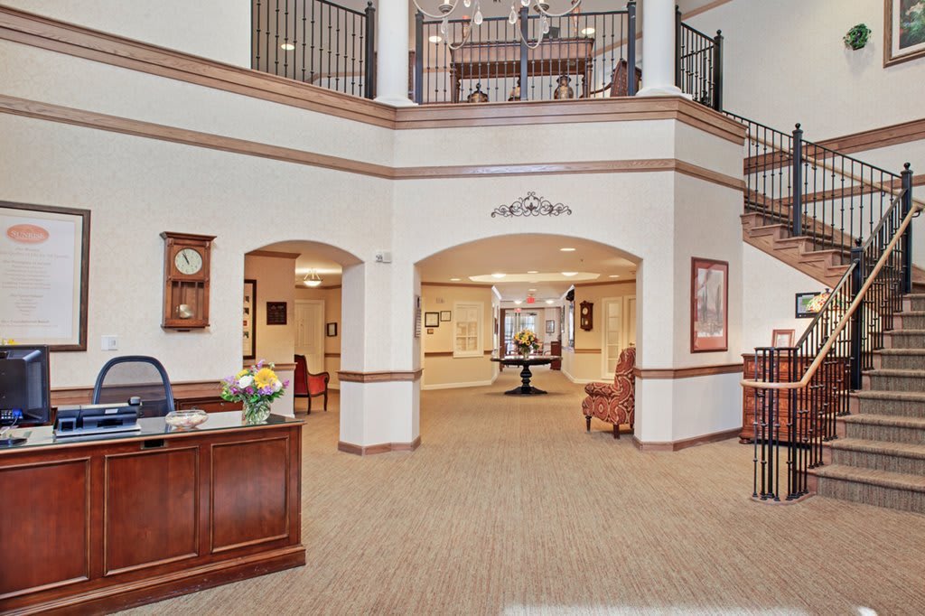 Spacious and elegantly designed lobby with a reception desk and comfortable seating area.