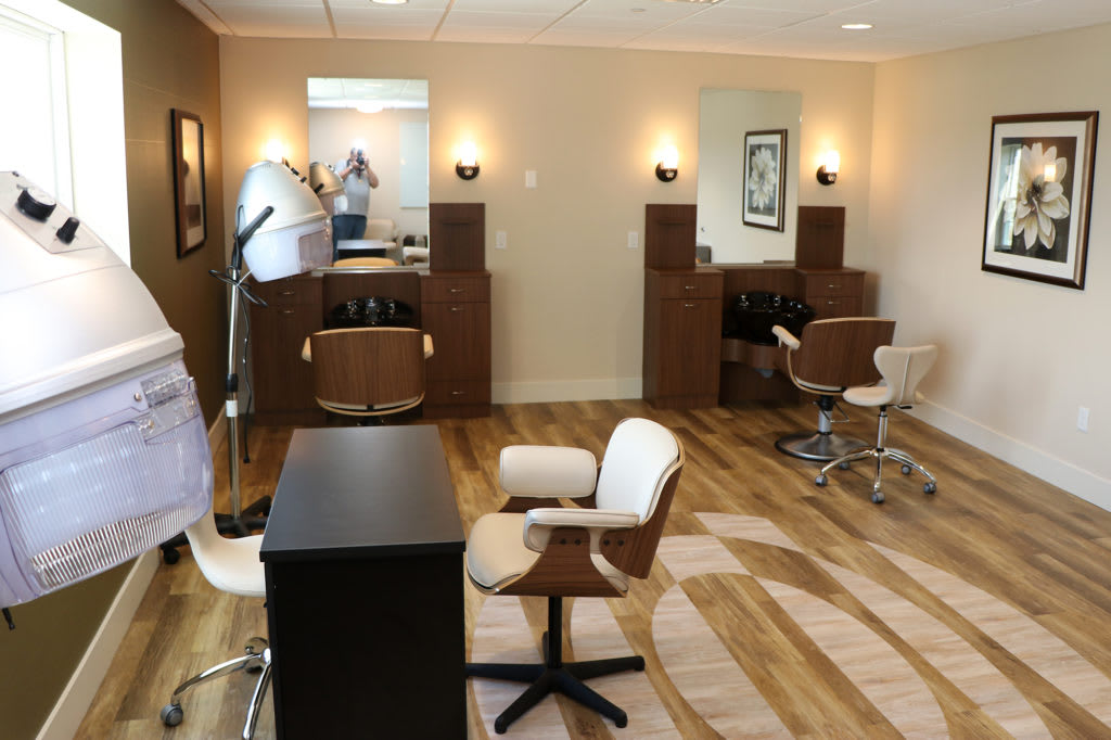 A modern hair salon interior with styling chairs and mirrors.