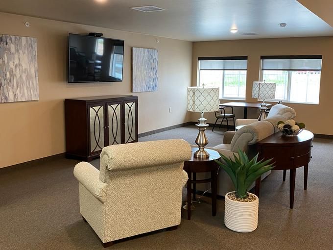 A cozy living room with a sofa, television, and decorative elements.