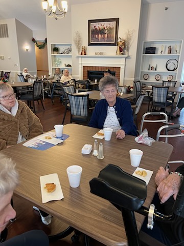 A group of seniors enjoying a conversation at a community center.
