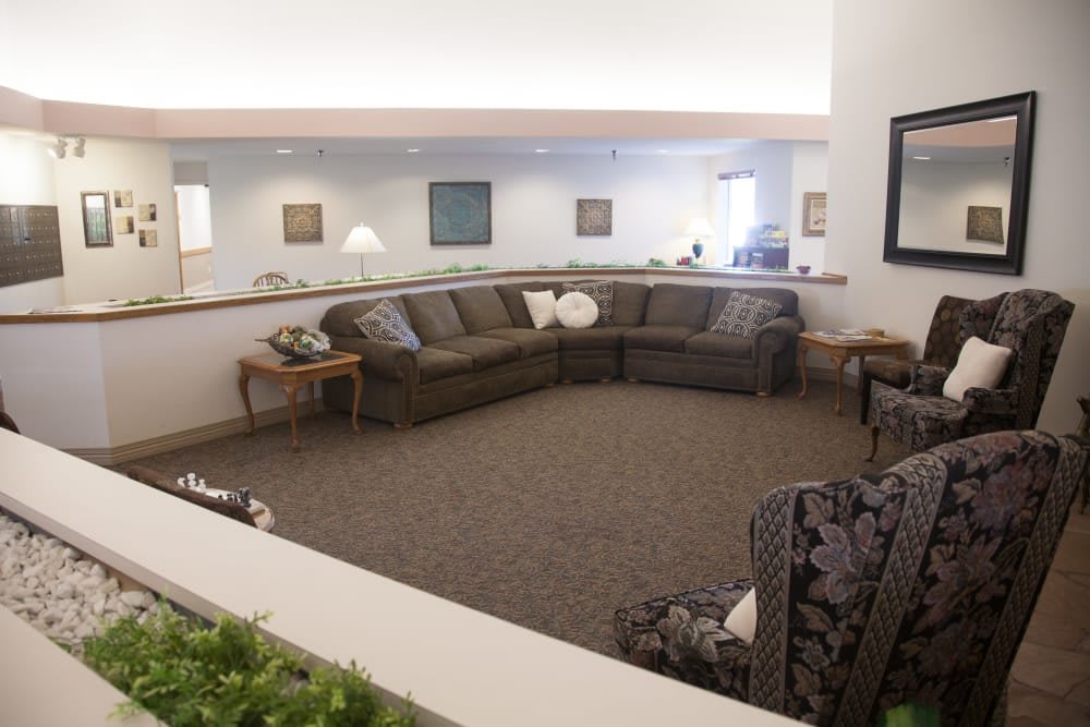 A spacious living room with a large sectional sofa and stylish decor.