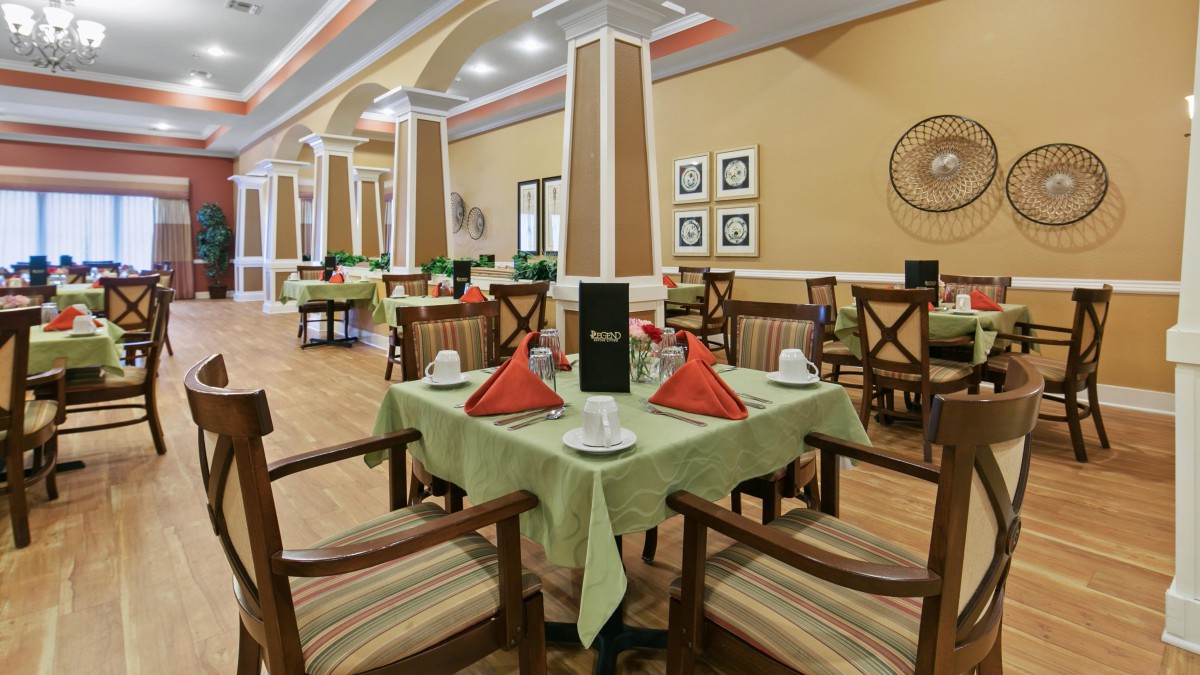 A neatly arranged dining area with elegantly set tables in a restaurant.