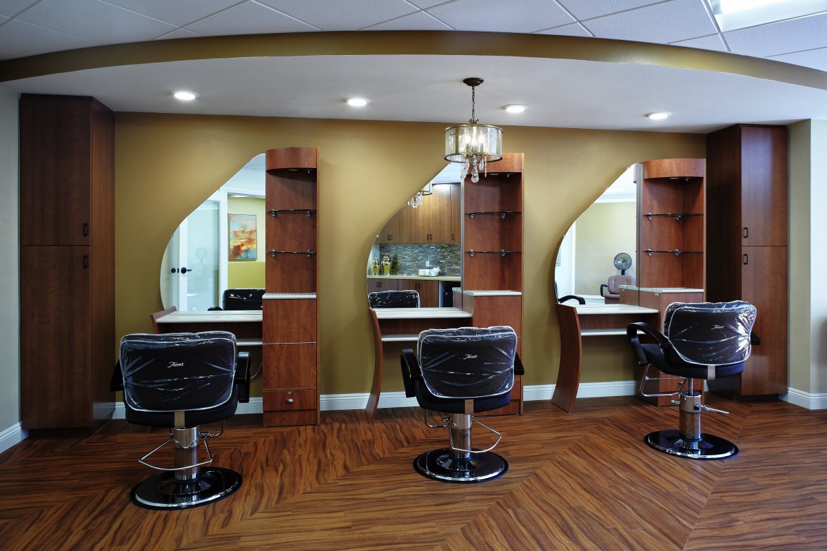 A modern hair salon interior with styling stations and mirrors.