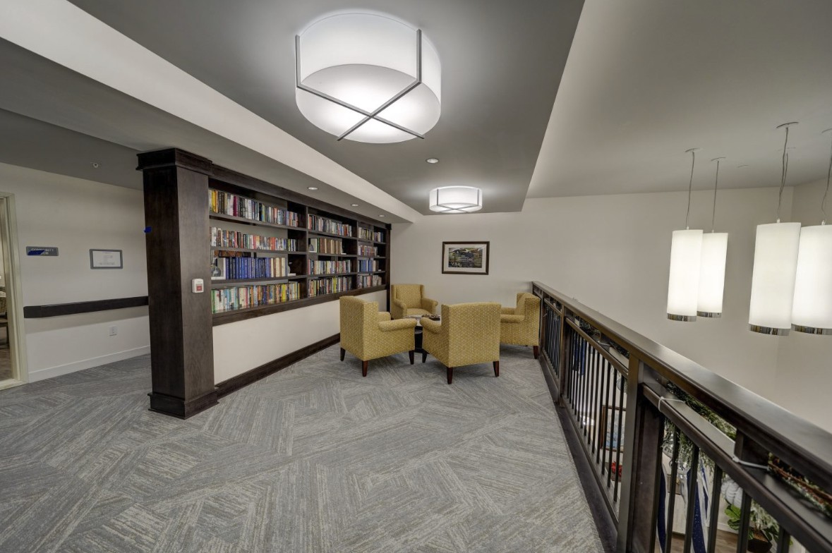 A cozy library corner with bookshelves and comfortable seating.