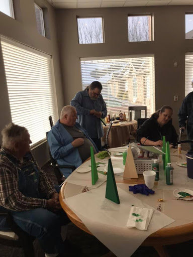 A group of individuals enjoying a social gathering around a table with decorations.