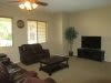 A cozy living room with a sofa, coffee table, and a TV.