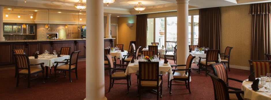 An elegant restaurant dining area with neatly arranged tables and chairs.