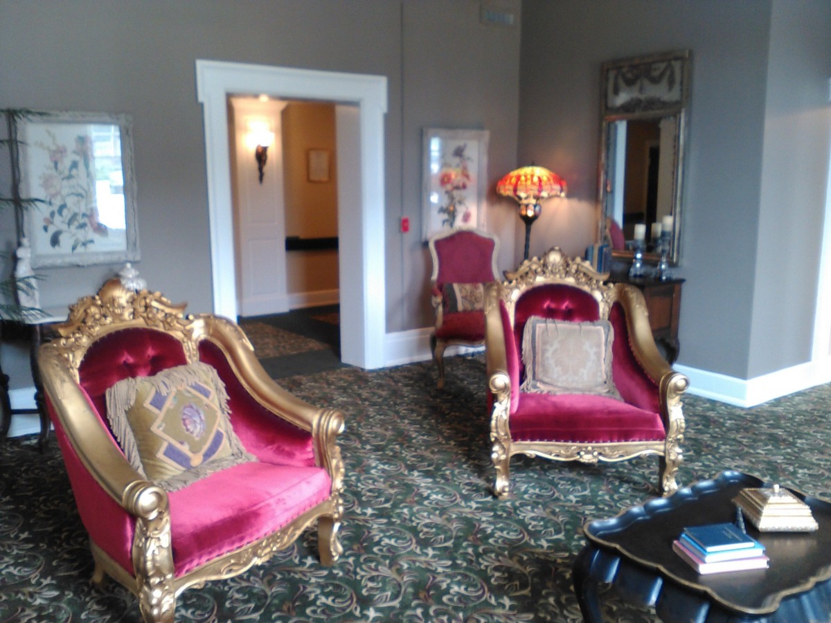 A luxurious living room featuring vintage armchairs and elegant decor.