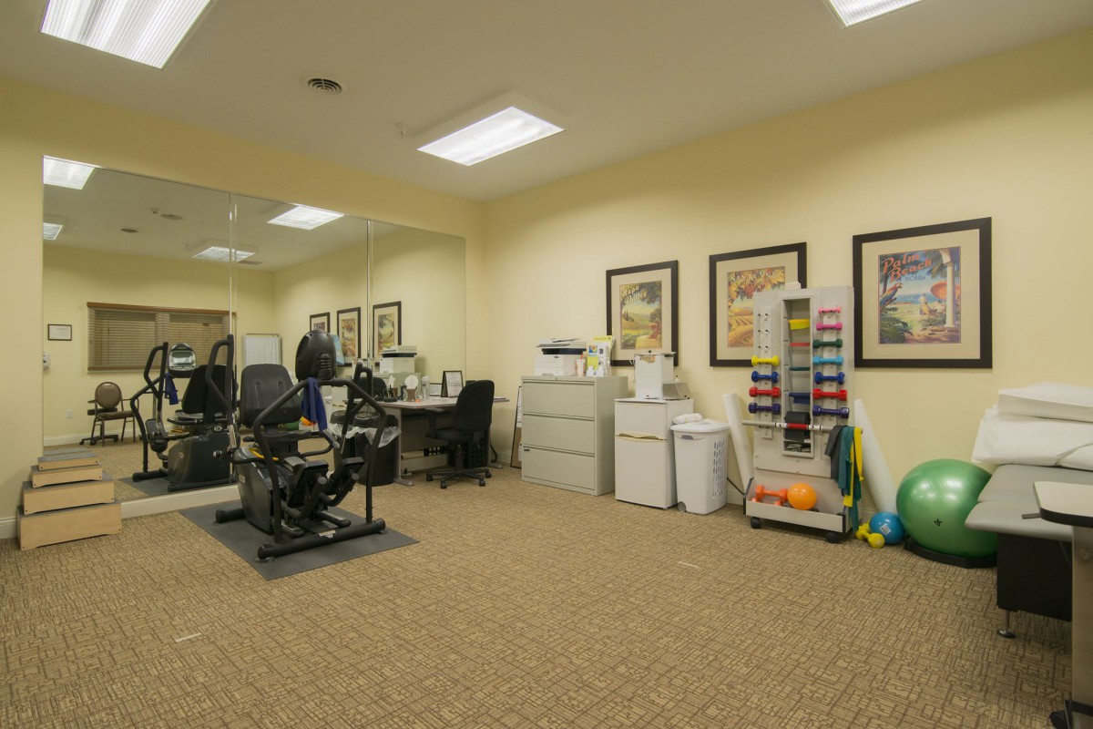 A modern office interior with desks, chairs, and framed artwork on the walls.