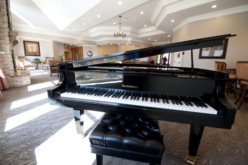 A grand piano in an elegant and spacious living room.