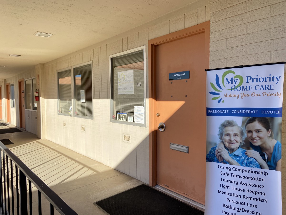 Entrance to a facility with signage and a banner outside.
