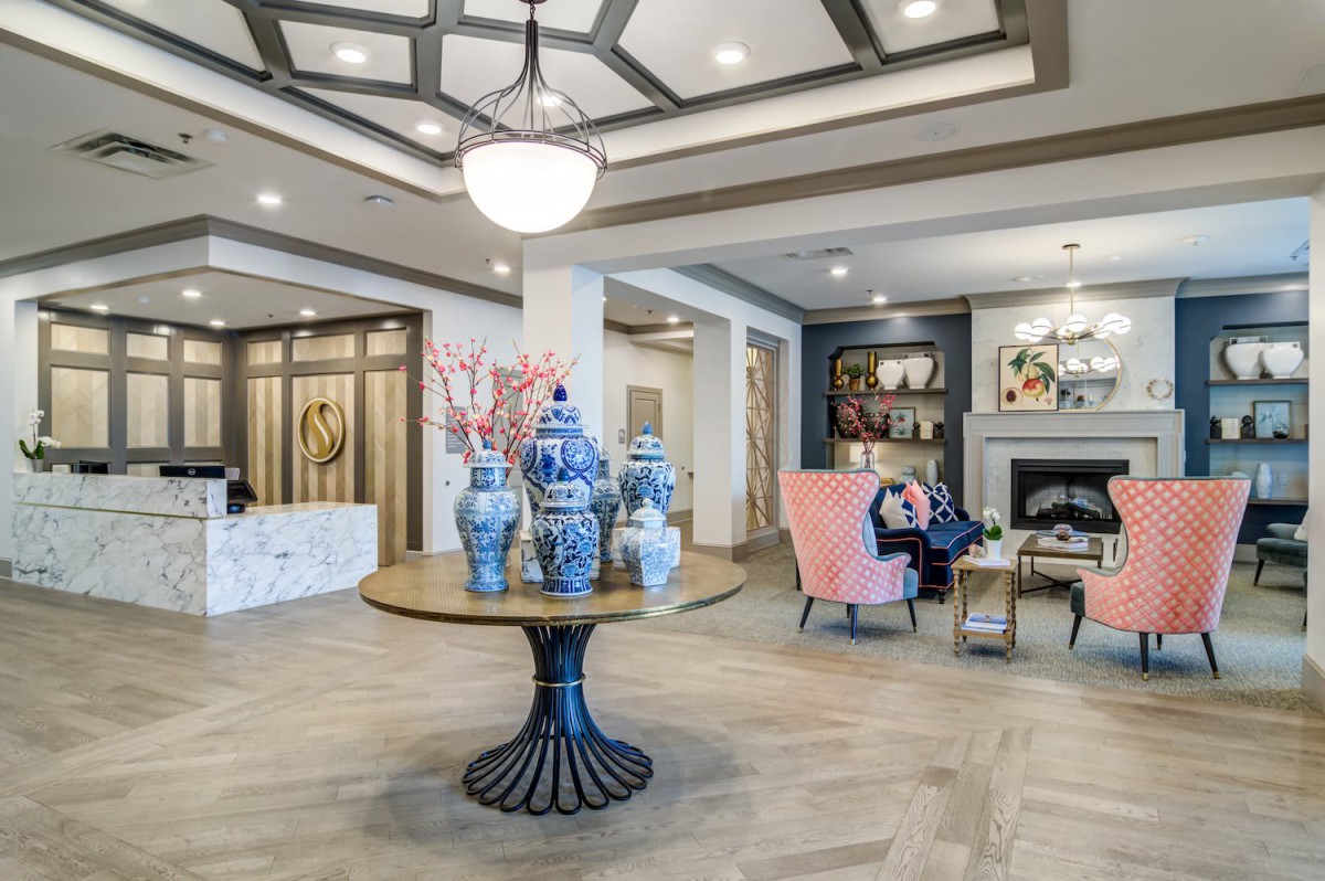 A modern, elegantly designed lobby area with decorative vases and comfortable seating.