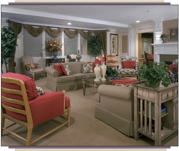 A cozy and elegantly furnished living room with stylish sofas, decorative cushions, a central coffee table, and lush indoor plants.