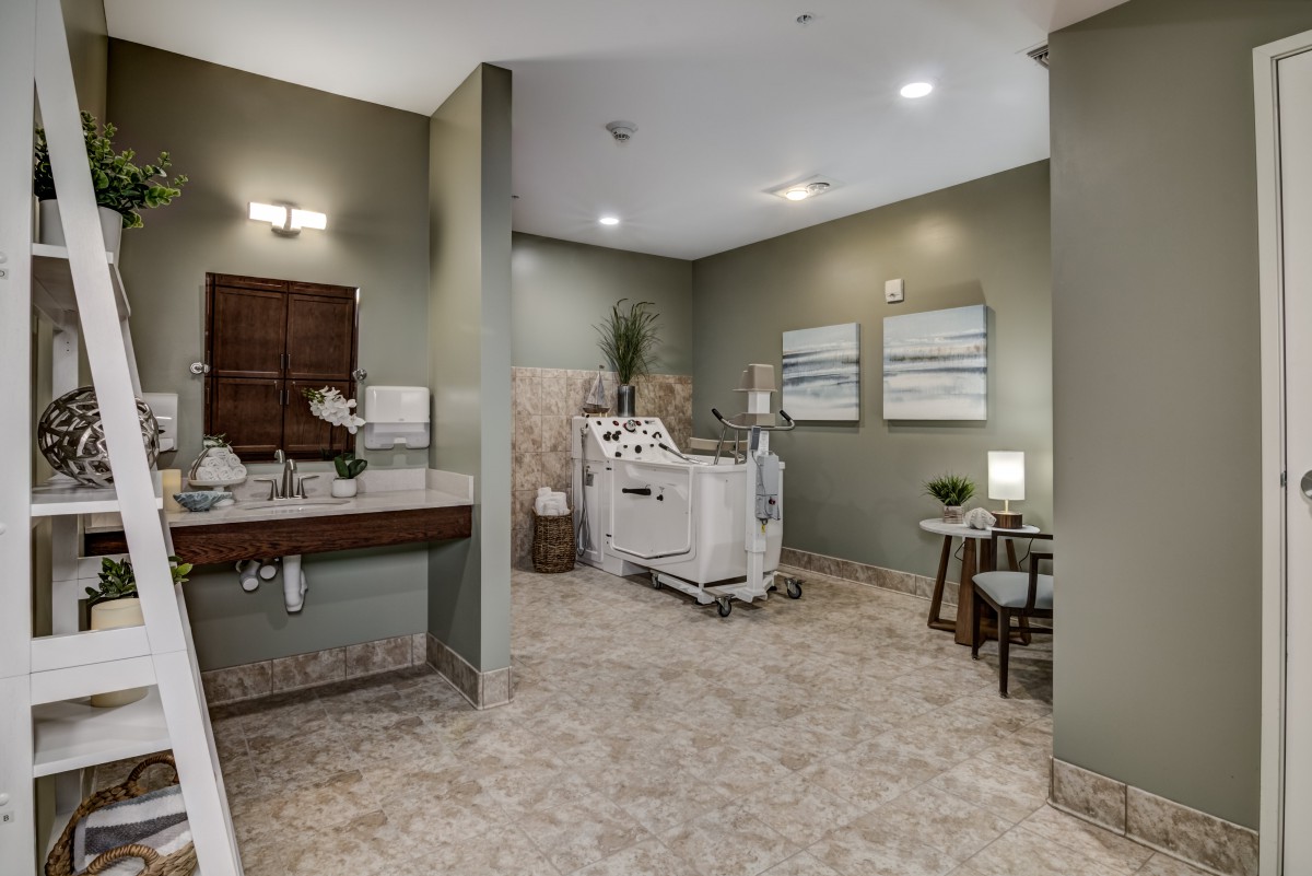 A modern healthcare room featuring medical equipment and stylish decor.