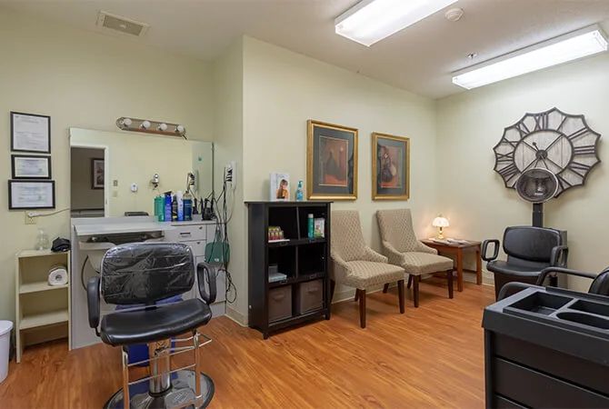 An interior view of a modern barbershop with chairs and grooming products.