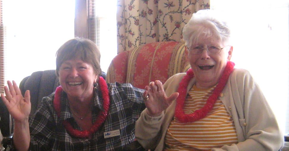 Two people smiling and enjoying time together indoors.