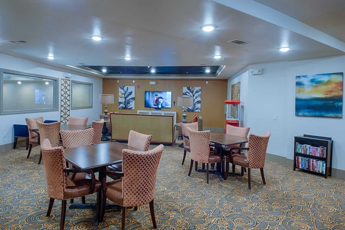 A well-lit meeting room with tables and chairs arranged for group discussions.