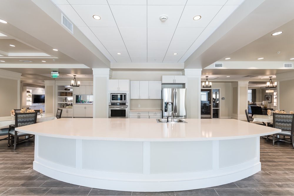 A modern and spacious kitchen with sleek countertops and built-in appliances.