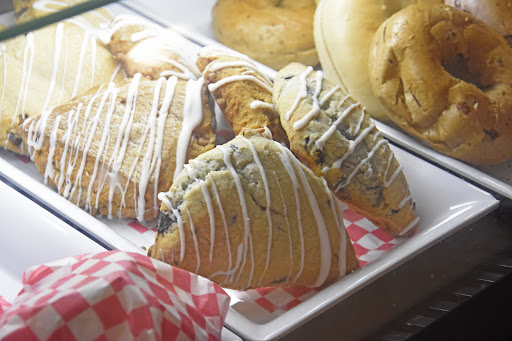 A delightful display of freshly baked pastries, including scones drizzled with icing.